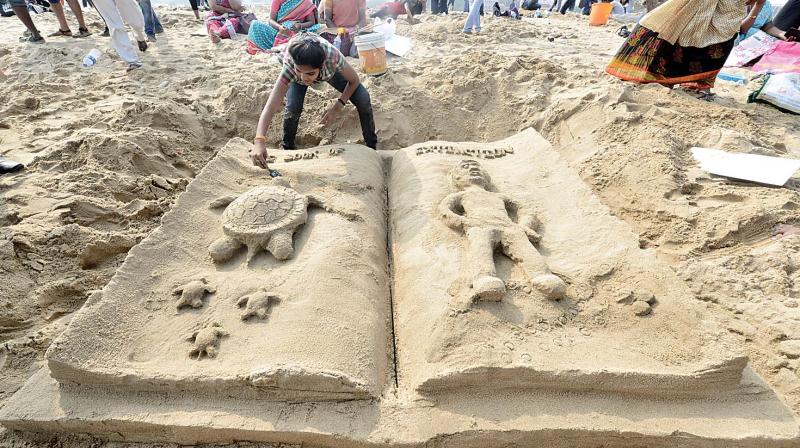 picture of a woman doing sand sculpture