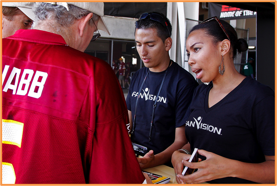 male and female brand ambassadors talking to an old man wearing red