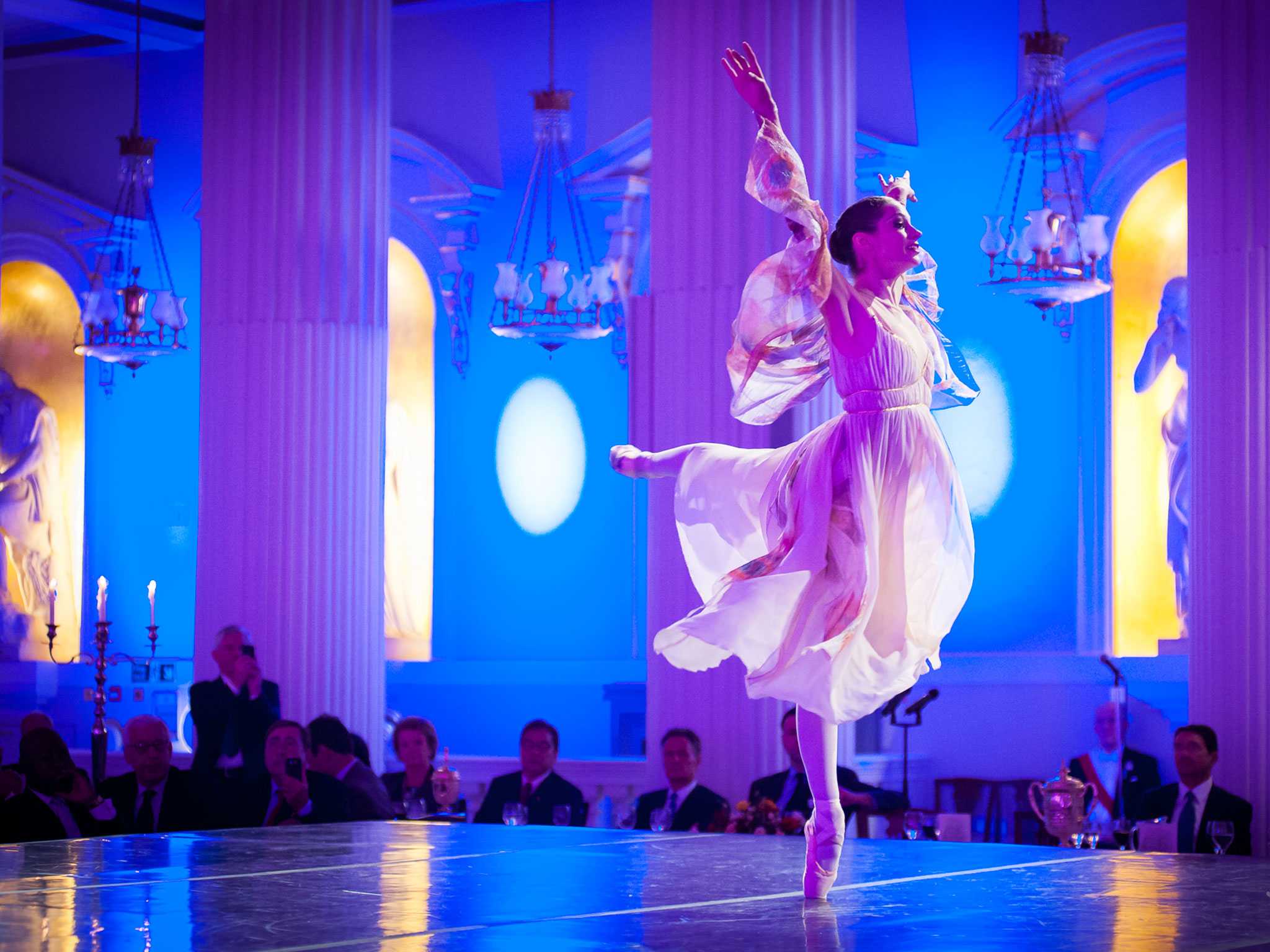 a ballerina is performing in front of audience