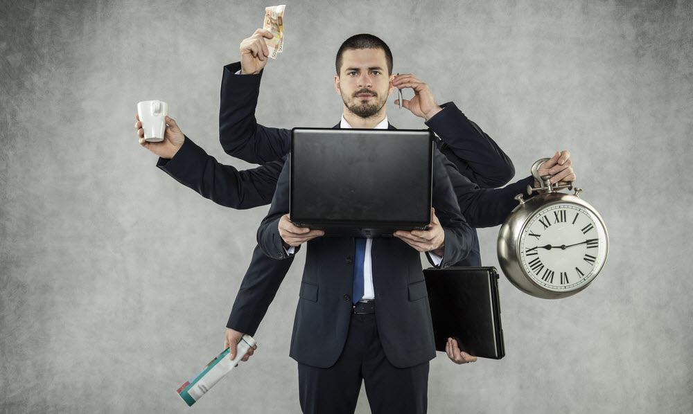 man holding computer with multiple hands holding objects