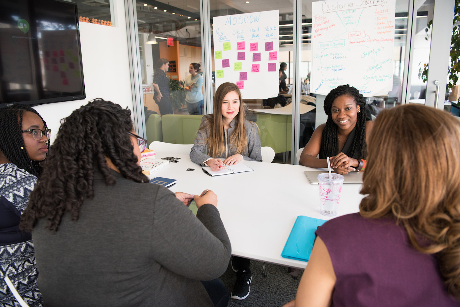 a group of women is holding a meeting