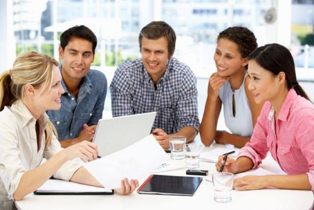 business team talking together holding papers on white table