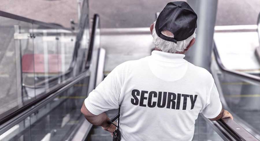 security personnel goinf down the escalator