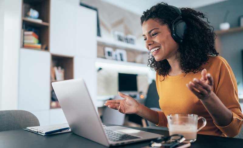 A woman talking into her computer. 