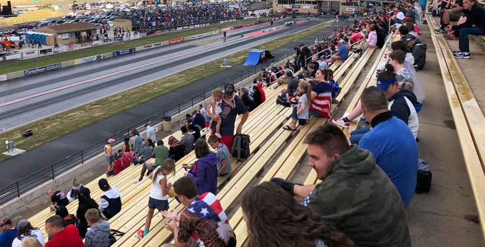 a-crowd-of-people-sitting-on-the-bleachers