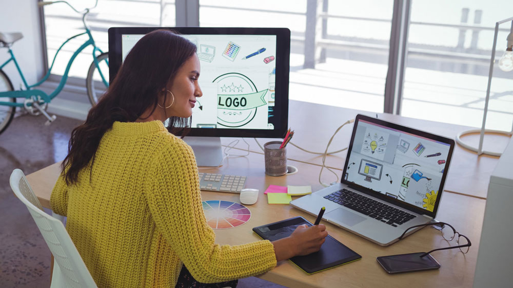 a-girl-with-a-yellow-jacket-working-on-her-computer-and-designing