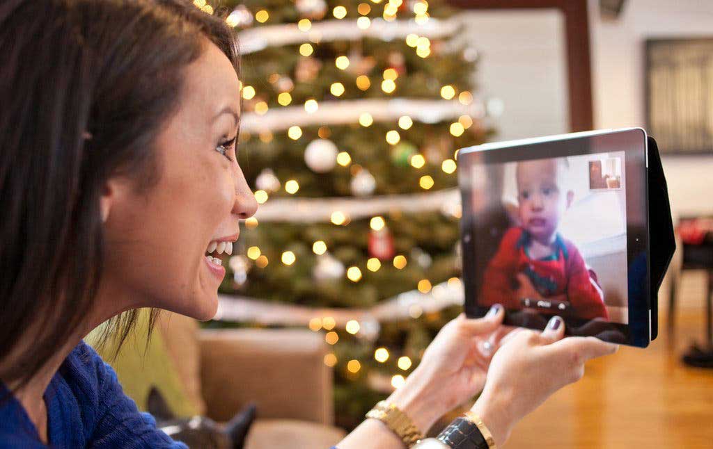 A-woman-talking-to-a-baby-through-a-screen