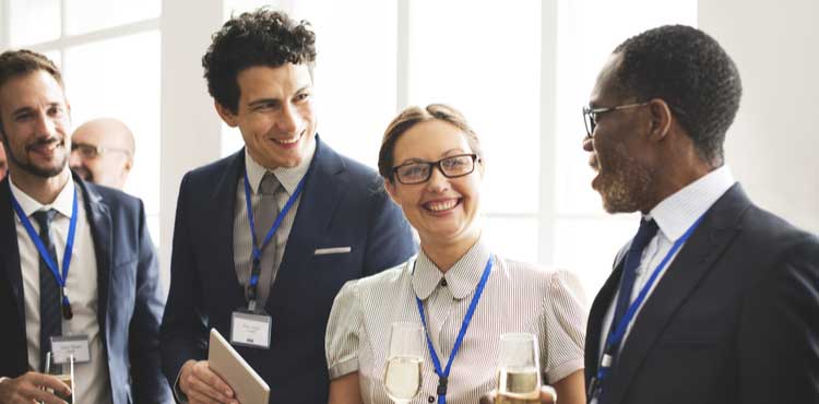 a-group-of-experts-smiling-and-talking-at-a-conference