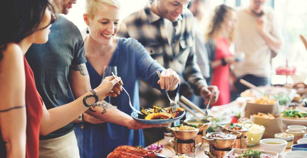 a-woman-in-a-buffet-line-getting-food