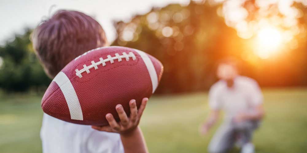 a-boy-holding-a-football-getting-ready-to-throw-it