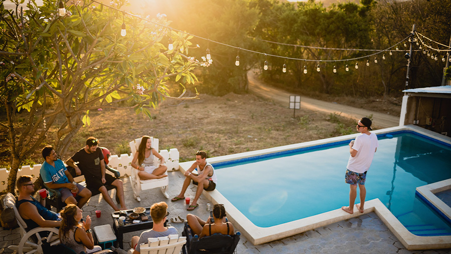 people-at-an-airbnb-and-a-man-standing-by-the-pool